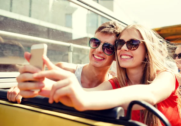 Lachende paar met smartphone maken selfie — Stockfoto