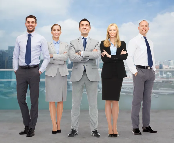 Group of smiling businessmen over city background — Stock Photo, Image