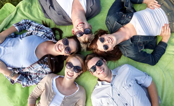 Group of students or teenagers lying in circle — Stock Photo, Image