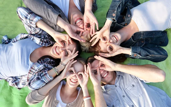 Group of students or teenagers lying in circle — Stock Photo, Image