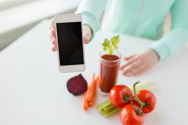 Close up of woman with smartphone and vegetables — Stock Photo, Image