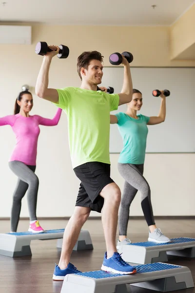 Group of people with dumbbells and steppers — Stock Photo, Image