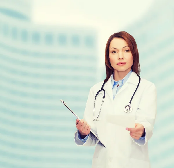 Calm female doctor with clipboard — Stock Photo, Image