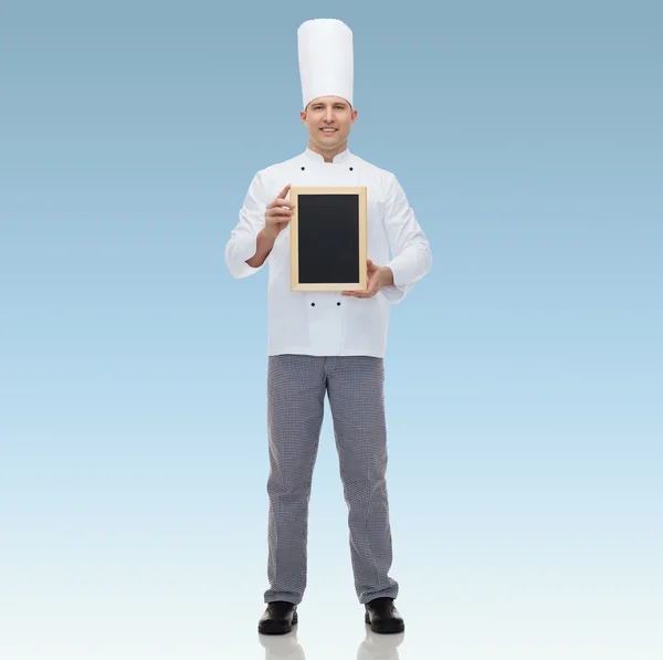 Happy male chef cook holding blank menu board — Stock Photo, Image