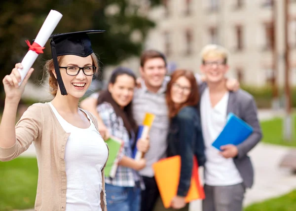 happy teenage students with diploma and folders