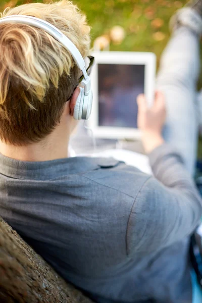 Close up of teenager in headphones with tablet pc — Stock Photo, Image
