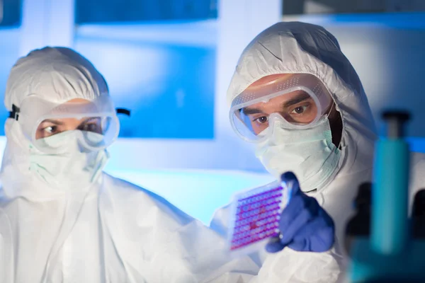 Close up of scientists making test in chemical lab — Stock Photo, Image