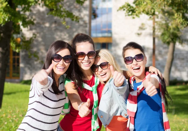 Happy teenage girls showing thumbs up at campus — Stock Photo, Image