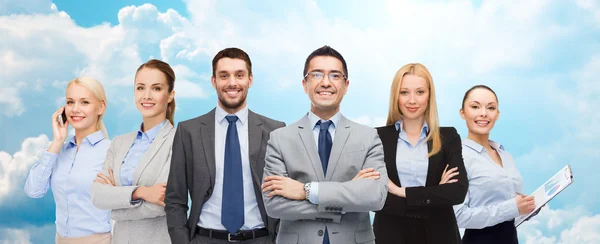 Group of smiling businessmen over blue sky — Stock Photo, Image