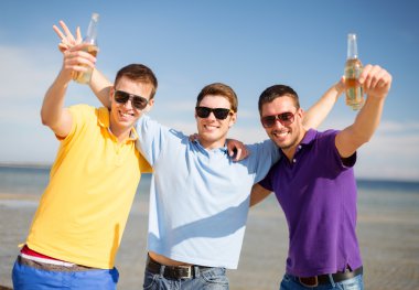 happy friends with beer bottles on beach clipart