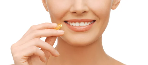 Beautiful woman with omega 3 vitamins — Stock Photo, Image