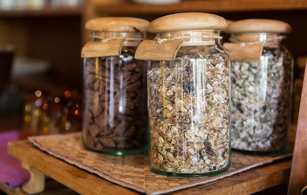 Close up of jars with granola at grocery store — Stock Photo, Image