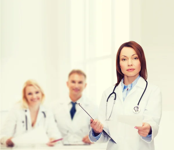 Calm female doctor with clipboard — Stock Photo, Image