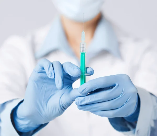 Female doctor holding syringe with injection — Stock Photo, Image