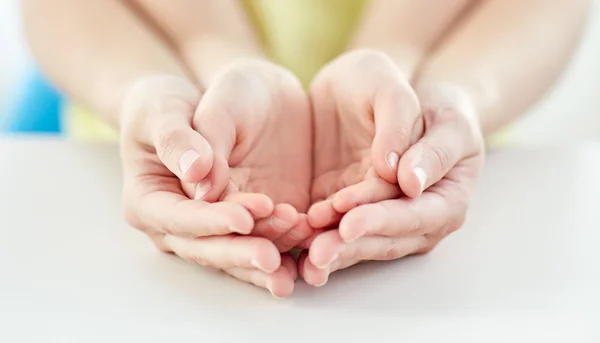 Close up of woman and girl with cupped hands — Stock Photo, Image