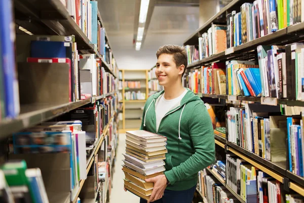 Happy student or man with book in library — Stock Photo, Image
