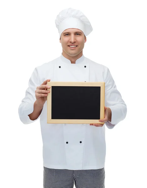 Happy male chef cook holding blank menu board — Stock Photo, Image