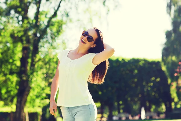 Lächelnde junge Frau mit Sonnenbrille im Park — Stockfoto