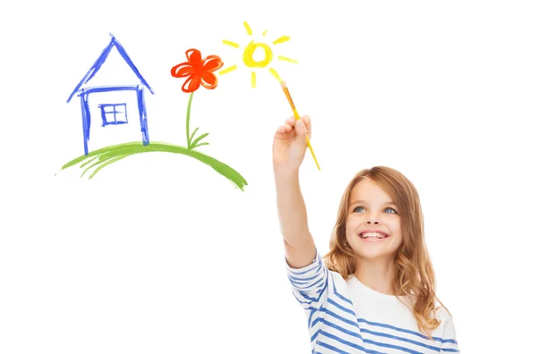 Cute little girl drawing house with brush — Stock Photo, Image