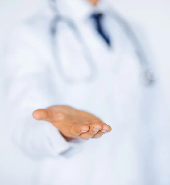 Male doctor holding something in his hand — Stock Photo, Image