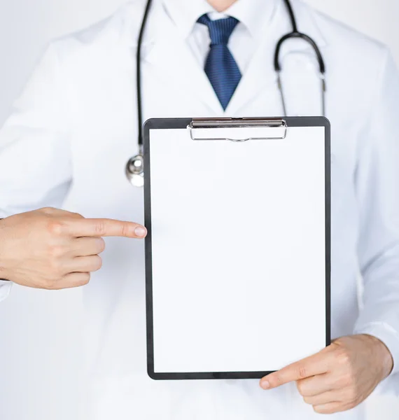 Doctor pointing at blank white paper Stock Image