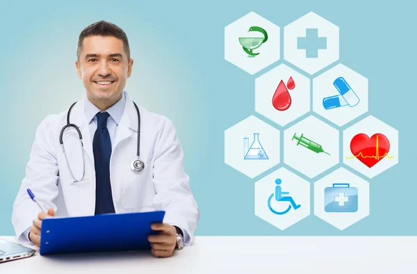 Happy doctor with clipboard and medical icons — Stock Photo, Image