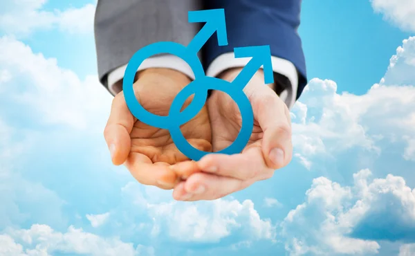 Close up of male gay couple holding gender symbol — Stock Photo, Image