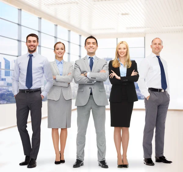 Group of smiling businessmen over office room — Stock Photo, Image