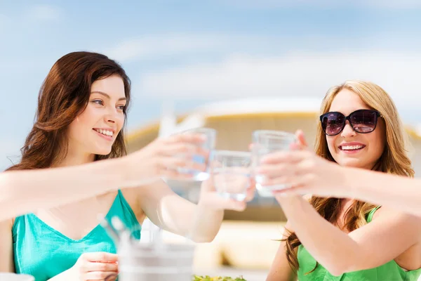 Girls making a toast in cafe on the beach — Stock Photo, Image