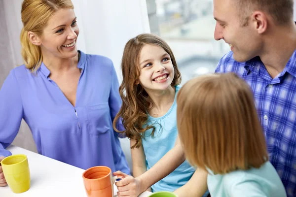 Happy family drinking tea with cups at home — Stock Photo, Image