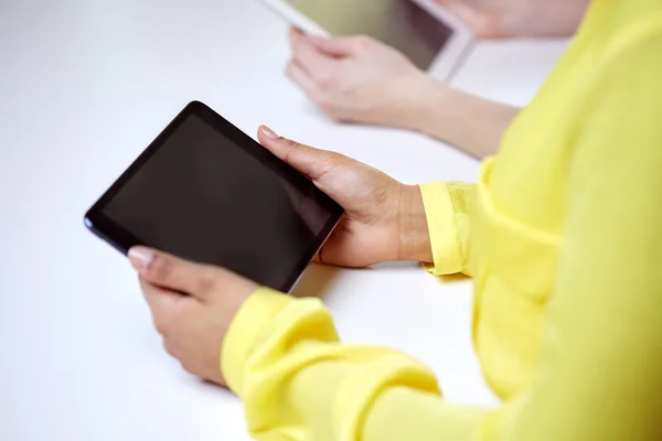 Close up of female hands with tablet pc at table — Stock Photo, Image