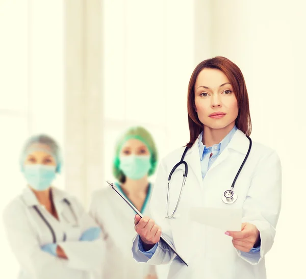 Calm female doctor with clipboard — Stock Photo, Image