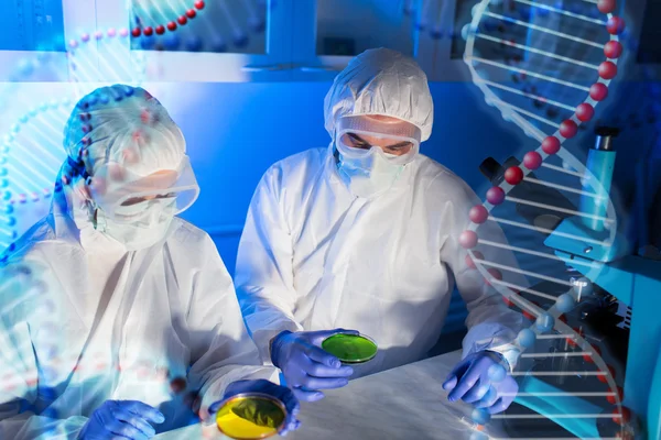 Close up of scientists with test samples in lab — Stock Photo, Image