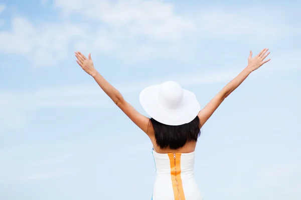 Girl with hands up on the beach — Stock Photo, Image