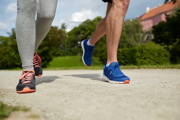 Close up of couple running outdoors — Stock Photo, Image