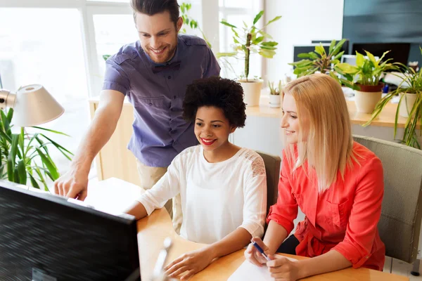 Lykkelig kreativ gruppe med datamaskin i embetet – stockfoto