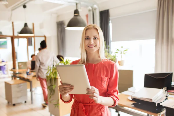 Happy creative female office worker with tablet pc — Stock Photo, Image