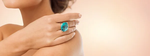 close up of woman with cocktail ring on hand