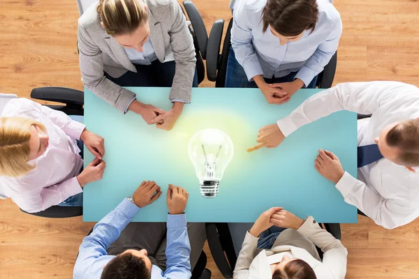 Close up of business team sitting at table — Stock Photo, Image