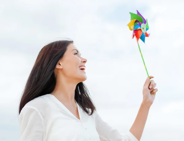 Girl with windmill toy on the beach — Stock Photo, Image