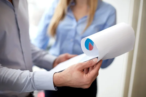 Close up of business team looking at clipboard — Stock Photo, Image