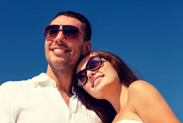 Smiling couple over blue sky background — Stock Photo, Image
