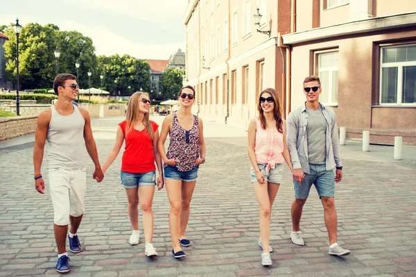 Group of smiling friends walking in the city — Stock Photo, Image