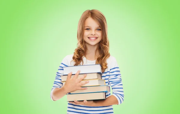 Heureuse petite étudiante avec beaucoup de livres — Photo