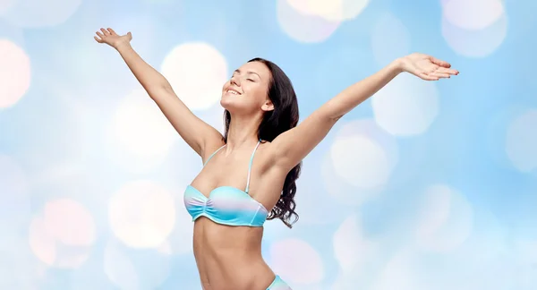 Happy woman in bikini swimsuit with raised hands — Stock Photo, Image