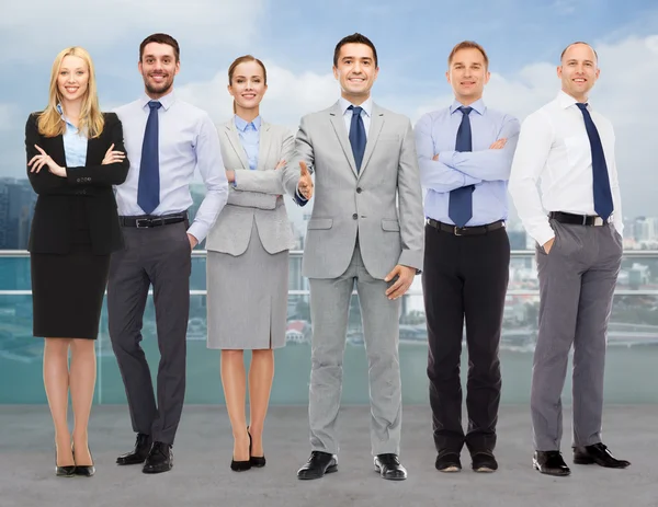 Group of smiling businessmen making handshake — Stock Photo, Image