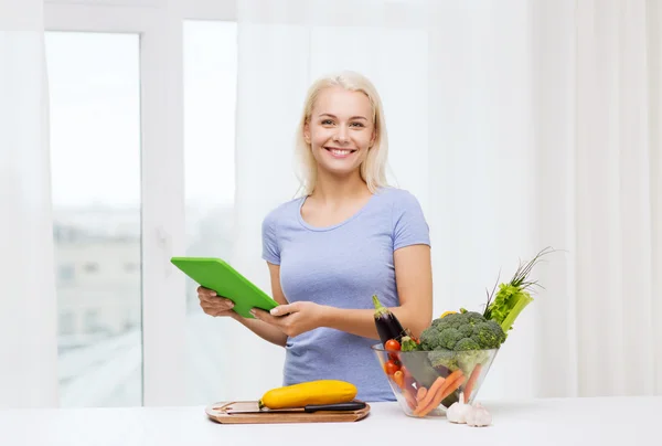 Mosolygó fiatal nő, tablet pc otthon főzés — Stock Fotó