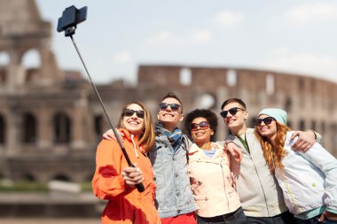 happy friends with smartphone selfie stick clipart