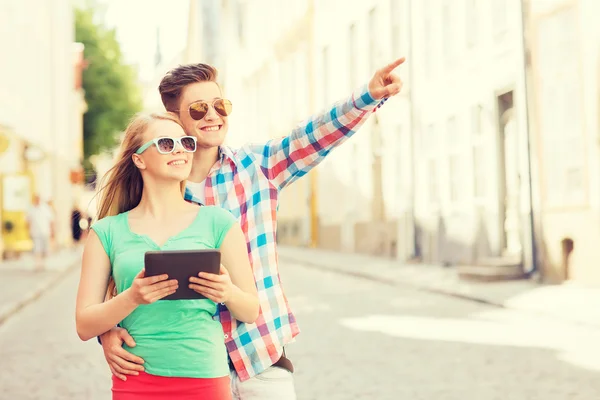 Sonriente pareja con tablet pc en la ciudad — Foto de Stock