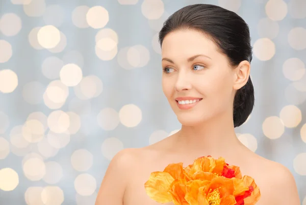 Beautiful young woman with flowers — Stock Photo, Image